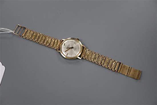 A gentlemans late 1960s 9ct gold Record de Luxe automatic wrist watch, on an associated 9ct gold strap, gross 47 grams,